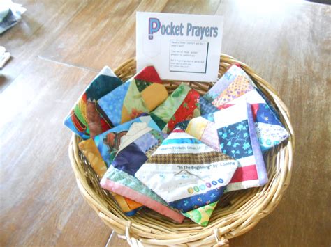 A person holding a pocket prayer quilt with a calm expression