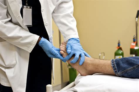 Podiatric Surgeon Examining Patient