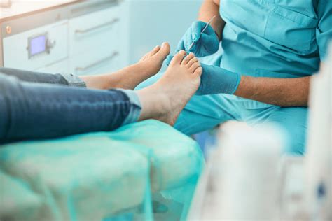 A podiatrist working with a patient