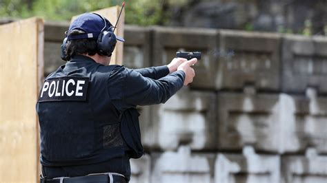 Police Officer Shooting Pistol at Range