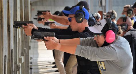 Police officer training with pistol