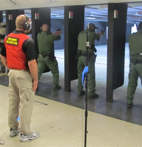 Police officer participating in training exercise with pistol