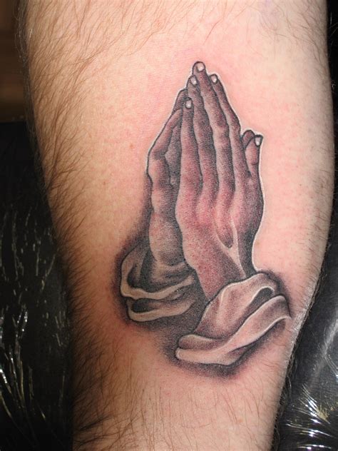 Praying hands tattoo symbolism