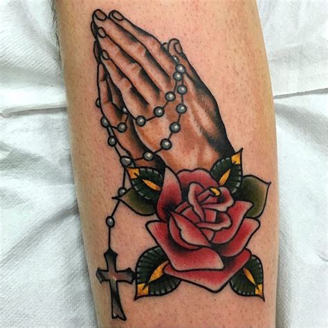 Praying hands tattoo with rosary