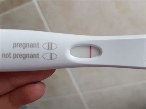 A woman looking at her pregnancy test results