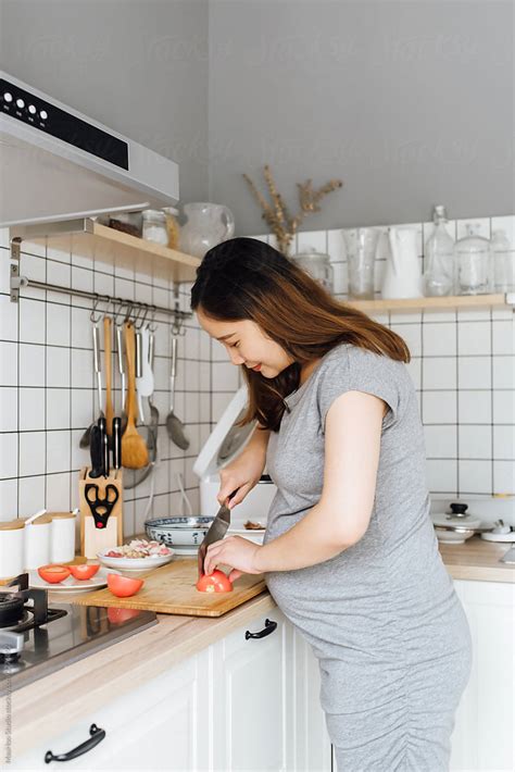 Pregnant woman cooking a healthy meal