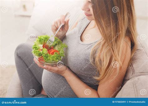 Pregnant woman holding fresh produce