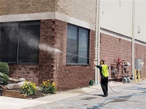 Pressure washing a building exterior