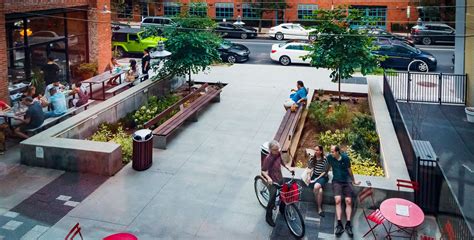 A public plaza with a fountain and seating areas