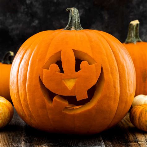 A person carving a pumpkin