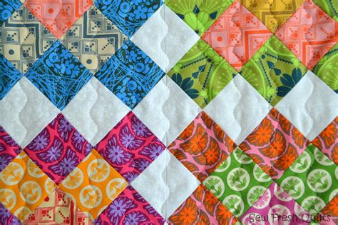 A quilter arranging blocks into a pattern