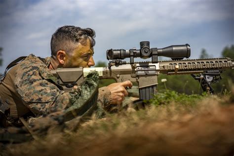 Recon Sniper using camouflage in a desert environment