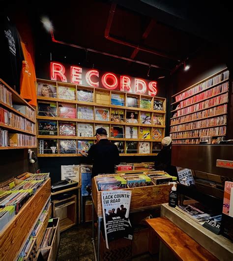 A record store owner surrounded by vinyl records