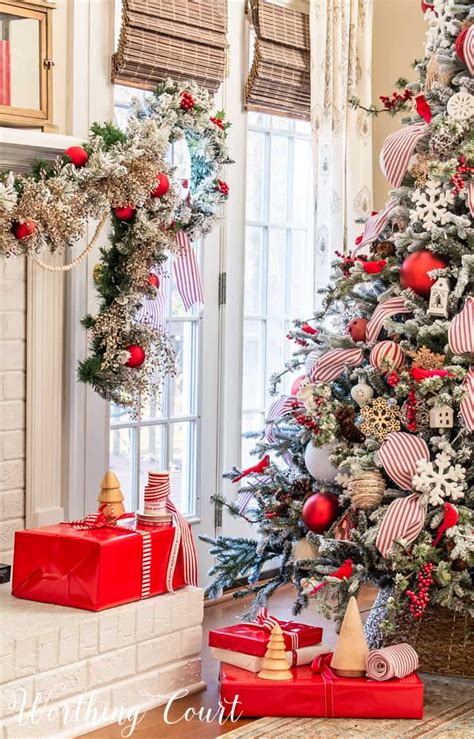 Red and white Christmas tree decorated with gold ornaments and lights