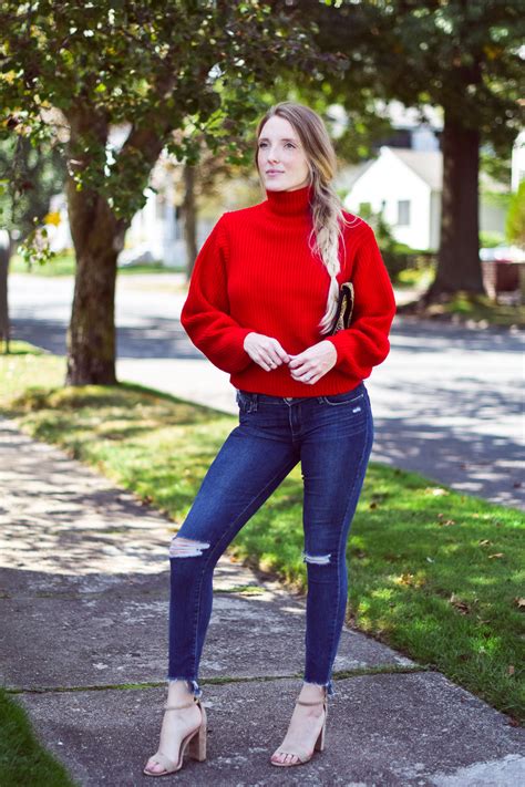 Woman wearing a red sweater with a festive holiday scarf