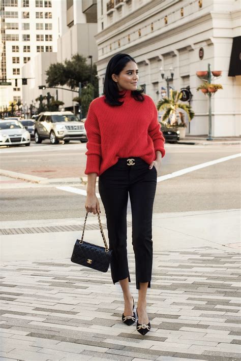 Woman wearing a red sweater with a festive holiday skirt