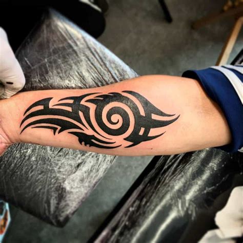 Red tribal forearm tattoo