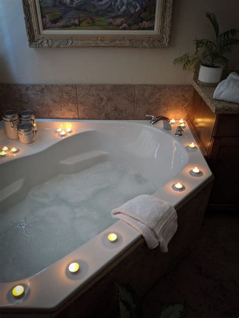 Woman soaking in a bathtub with rose petals