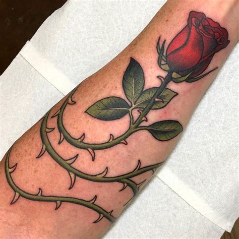 Rose tattoo with thorns design