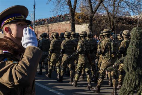 Soldiers saluting during a memorial service