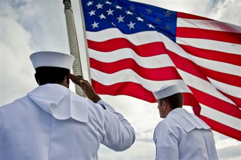 Soldiers saluting during a graduation ceremony