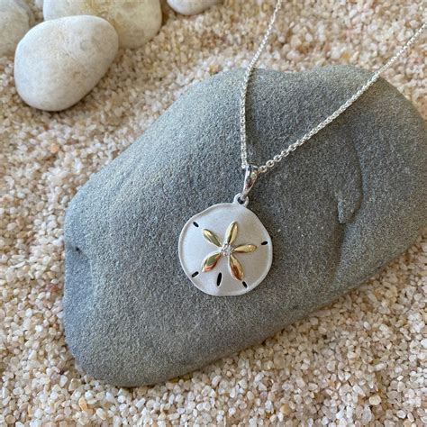 A sand dollar necklace, showcasing the creature's unique shape