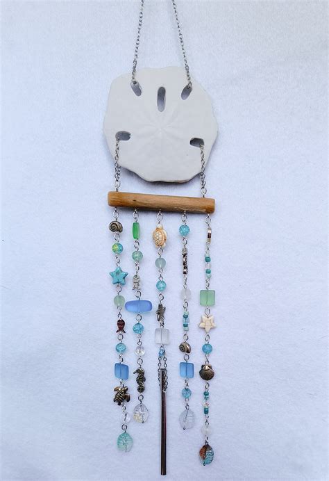 A sand dollar wind chime, adding a touch of the ocean's magic to a garden