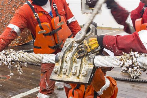 A photo of a group of seamen in training, practicing their rope-tying skills