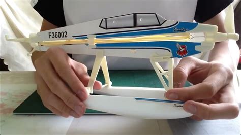 A person assembling a remote control seaplane