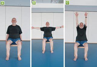 Senior performing seated arm raises