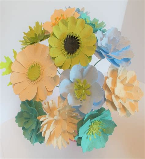 A woman holding a blooming seed paper bouquet