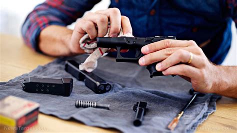 A person performing self-defense handgun maintenance and cleaning