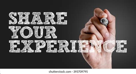 A photo of a person holding a sign that reads 'Share Your Experience'