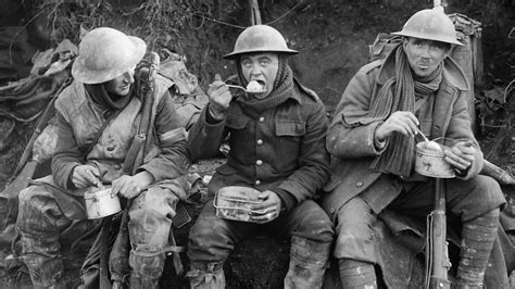 A soldier using a trench lighter to light a cigarette