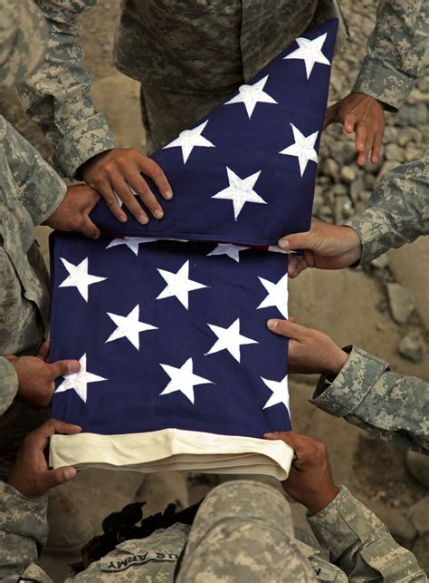 Soldiers folding the flag