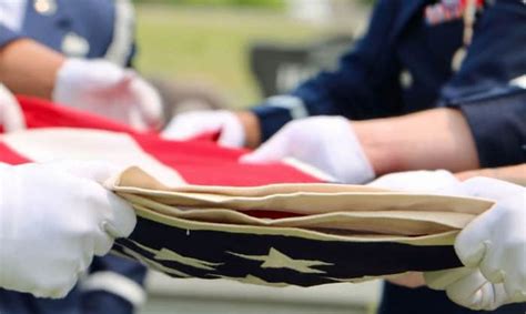 Soldiers folding the flag