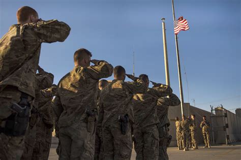 Soldiers lowering the flag