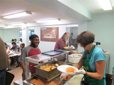 Soup kitchen volunteers serving breakfast