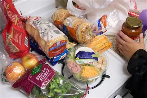 Image of a person holding a food stamp card