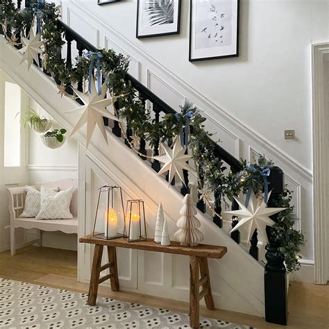 A majestic staircase adorned with a stunning gold bow and lush greenery