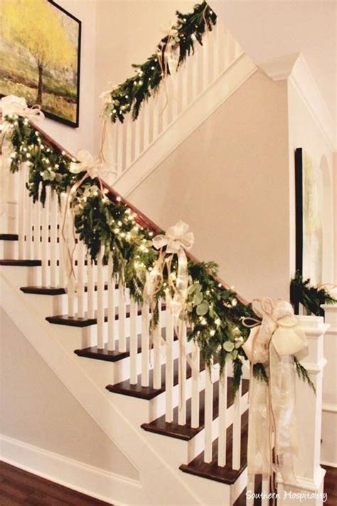 A majestic staircase adorned with a stunning gold bow and lush greenery