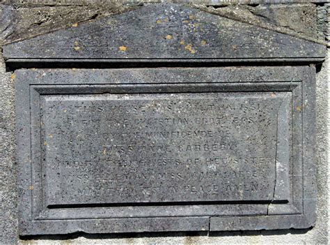 A stone plaque with a message in a serene garden