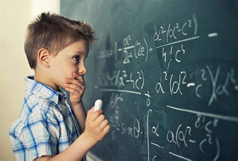 A student working on math problems with a times table chart