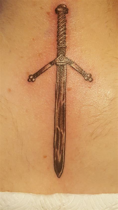 Sword tattoo with intricate hilt design