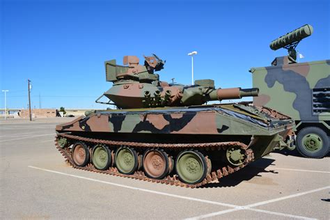 A close-up of a tank's armor plating, featuring bolts, rivets, and welds