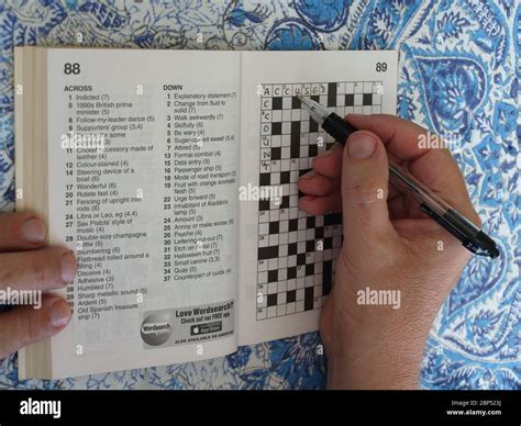 Teenager completing crossword puzzle