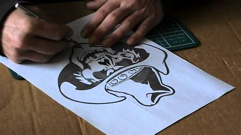 A person using a printable airbrush stencil to create artwork