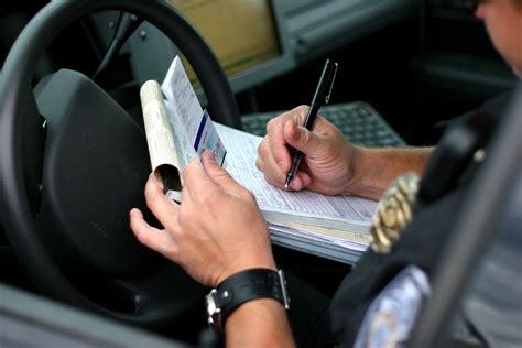 A driver paying fines for a traffic ticket