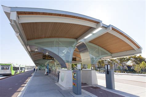 A bus station with people waiting for their ride