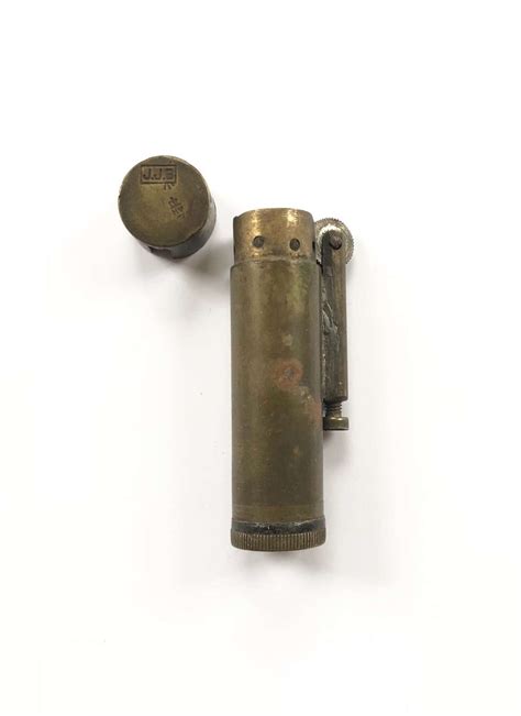 A World War II soldier holding a trench lighter